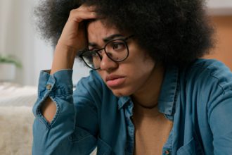 Sad worried African American woman upset suffer stress psychological problem anxiety depression