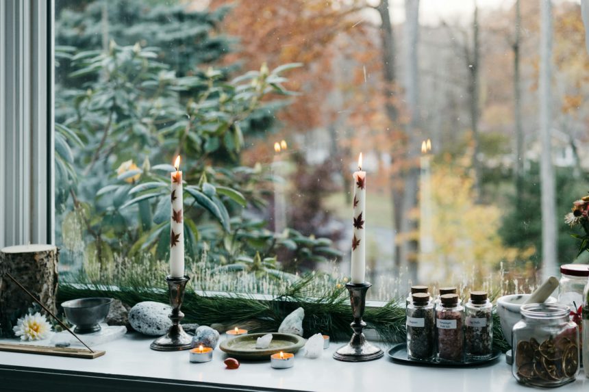 the windowsill is full of a variety of things and candles